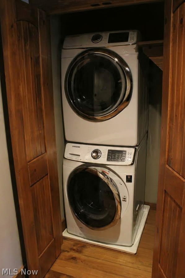 3989 Court Road Wakeman, OH 44889 - Photo 9 of 36 Laundry area featuring stacked washer / dryer and wood finished floors