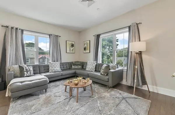a living room with furniture and a large window