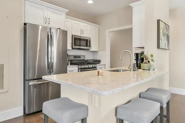 a kitchen with stainless steel appliances a refrigerator and a stove