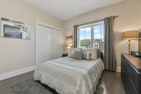 a bedroom with a bed and a lamp