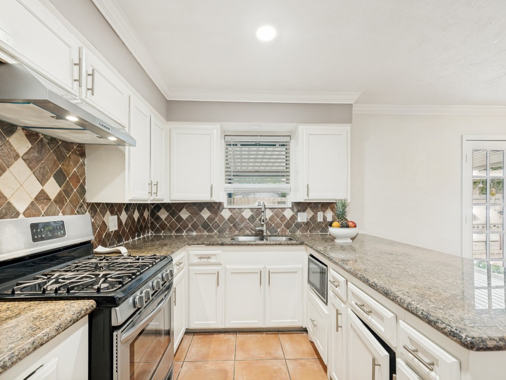 124 Bluebird Lane Pasadena, TX 77502 - Photo 11 of 25 a kitchen with a sink stove and cabinets