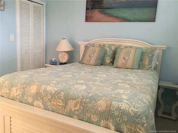 a bedroom with a bed and wall painting