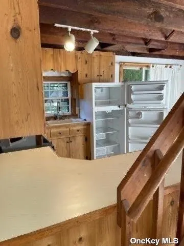 a kitchen with a refrigerator and sink