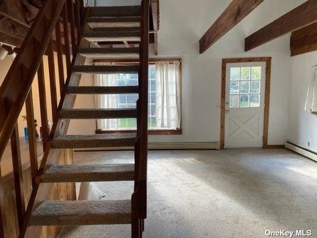 a view of an empty room with stairs