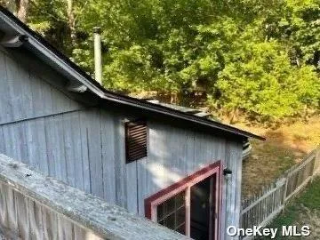 a side view of house with wooden fence