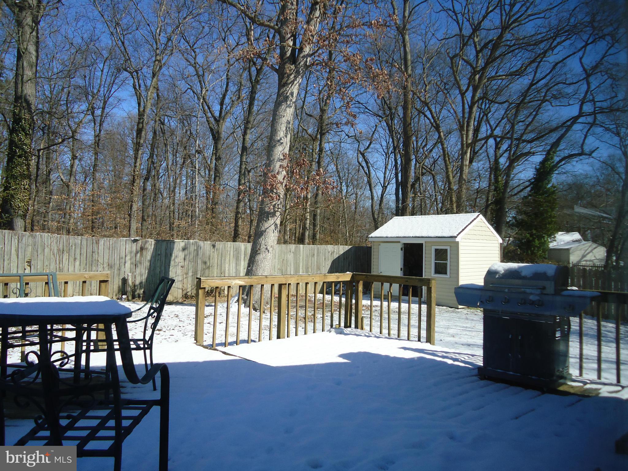 7031 Quander Road Alexandria, VA 22307 - Photo 5 of 12 a view of a chairs and table under an umbrella