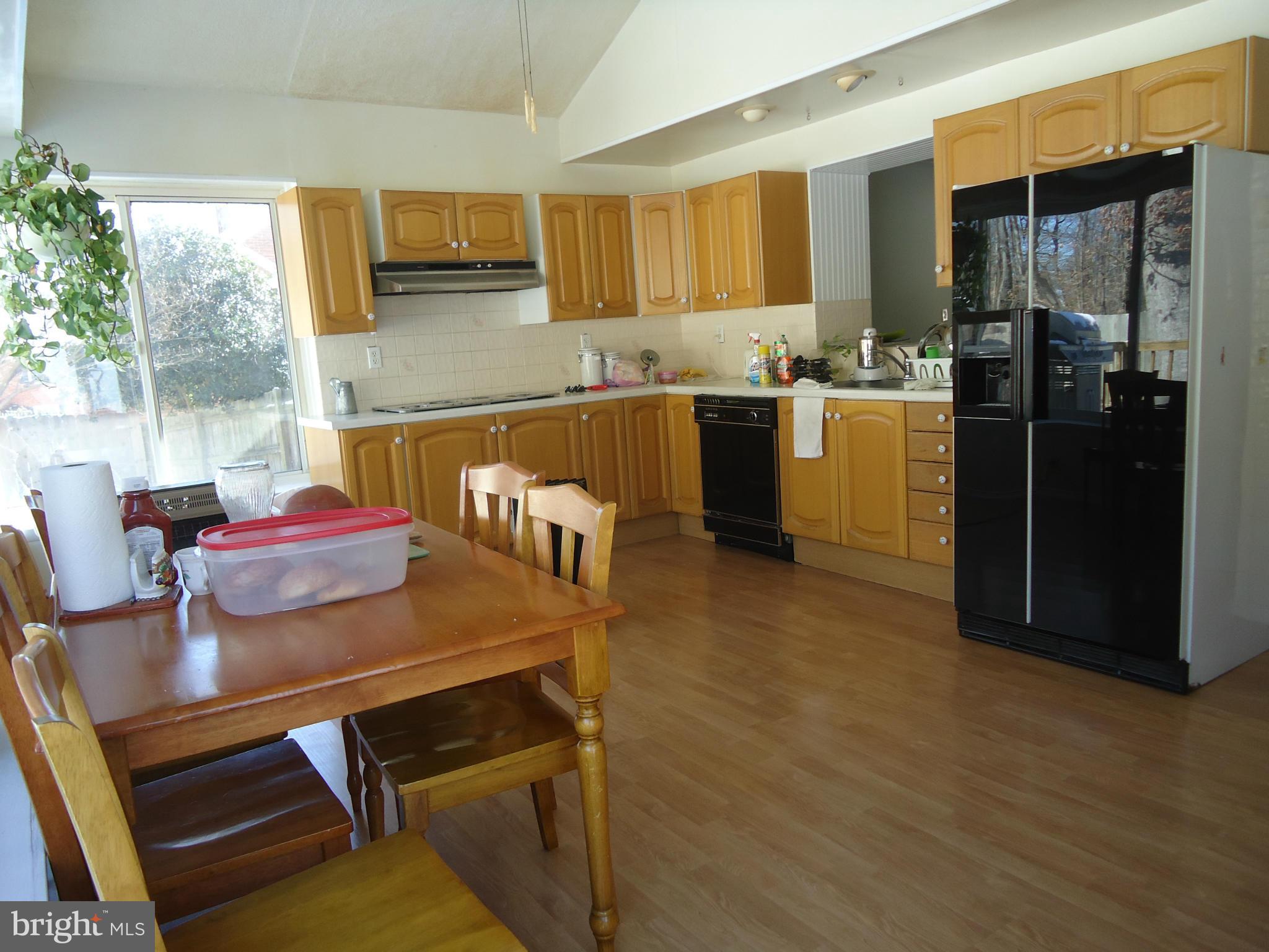 7031 Quander Road Alexandria, VA 22307 - Photo 6 of 12 a kitchen with a table chairs and refrigerator