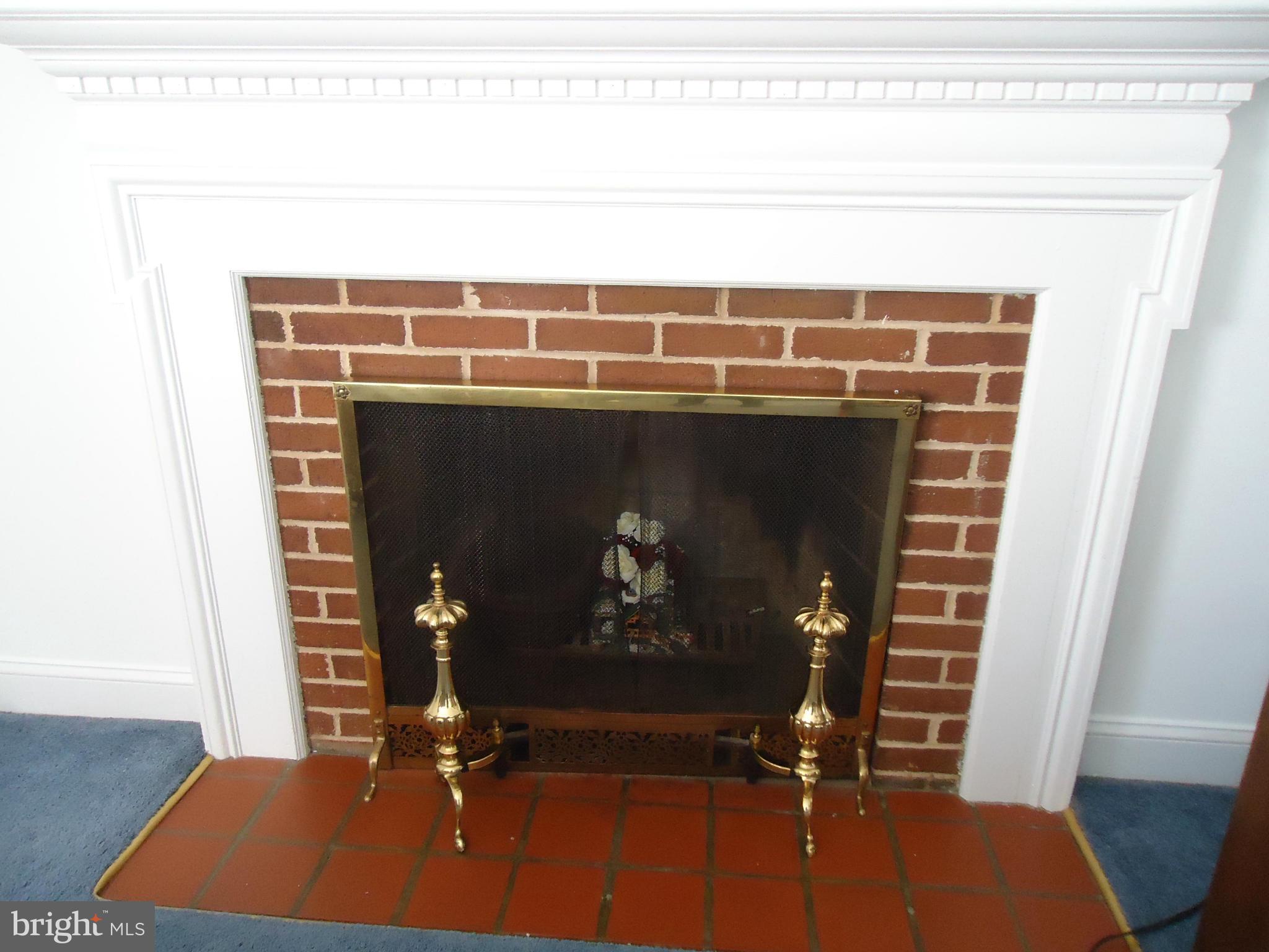 7031 Quander Road Alexandria, VA 22307 - Photo 7 of 12 a room with a fireplace and wooden floor