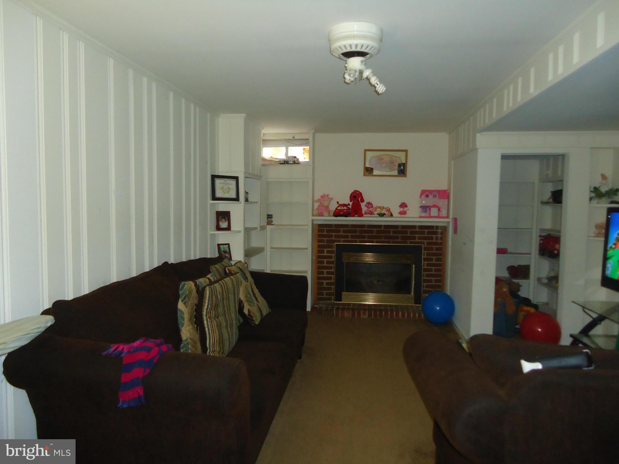 7031 Quander Road Alexandria, VA 22307 - Photo 8 of 12 a living room with furniture and a fireplace