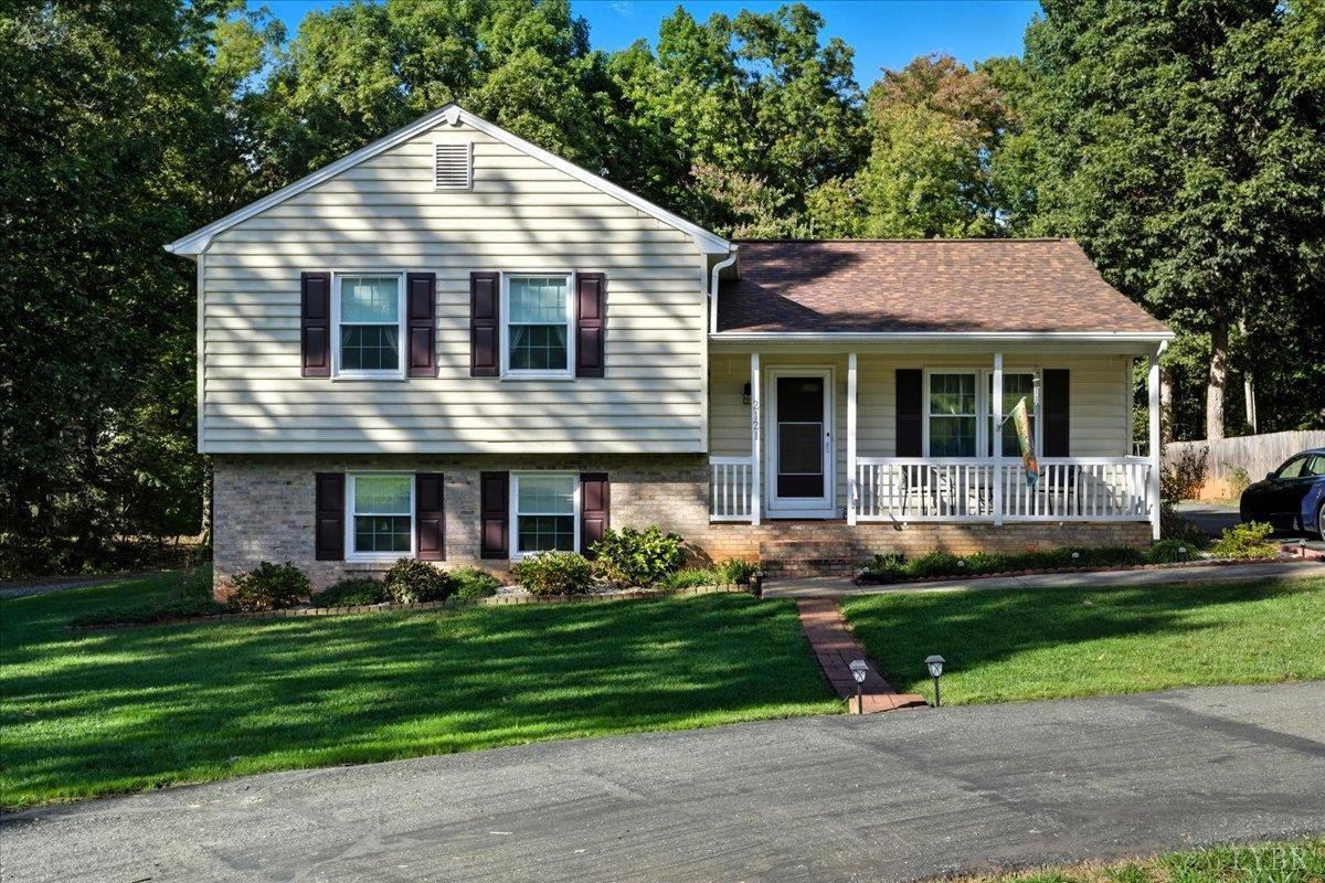 a front view of a house with a yard and plants