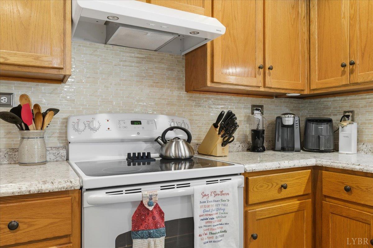 2121 Sunburst Road Evington, VA 24550 - Photo 11 of 41 a kitchen with granite countertop cabinets sink and stove