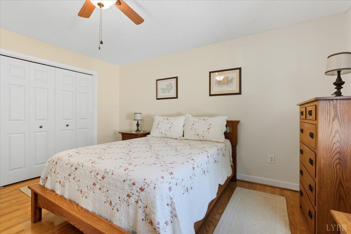 2121 Sunburst Road Evington, VA 24550 - Photo 16 of 41 a bedroom with a bed and a chandelier