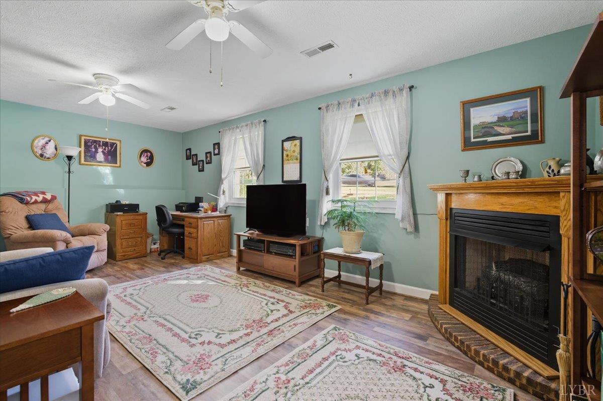 2121 Sunburst Road Evington, VA 24550 - Photo 26 of 41 a living room with furniture a flat screen tv and a fireplace