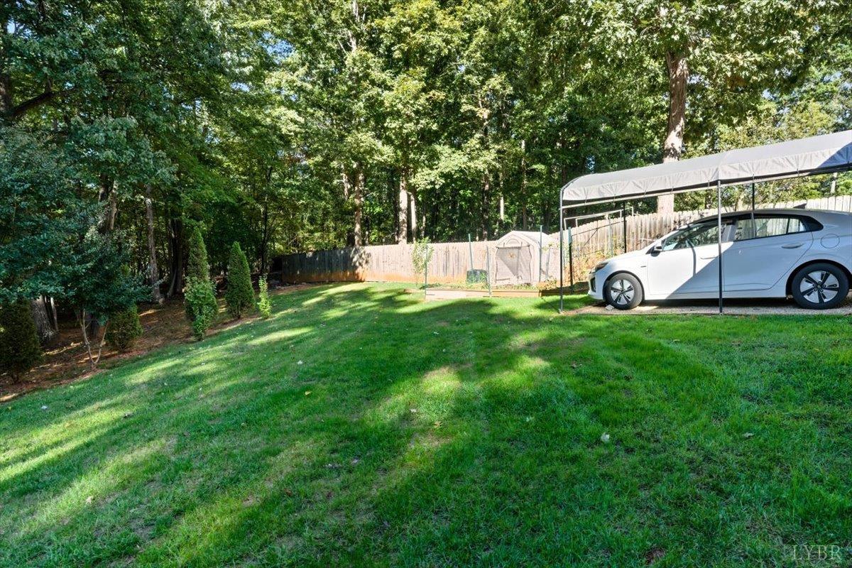 2121 Sunburst Road Evington, VA 24550 - Photo 31 of 41 a view of a white house with a big yard and large trees