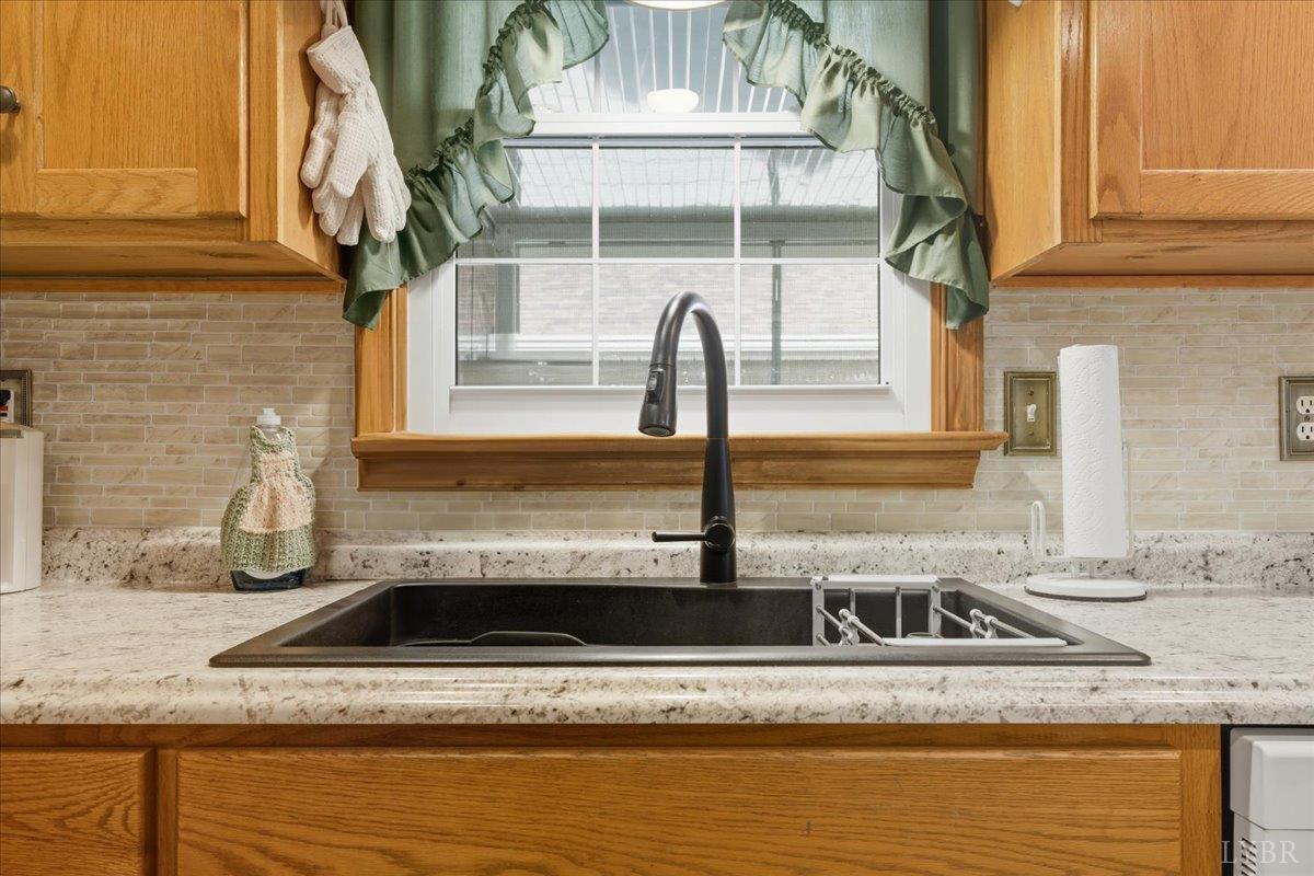 2121 Sunburst Road Evington, VA 24550 - Photo 10 of 41 a view of a kitchen with granite countertop a sink and a stove