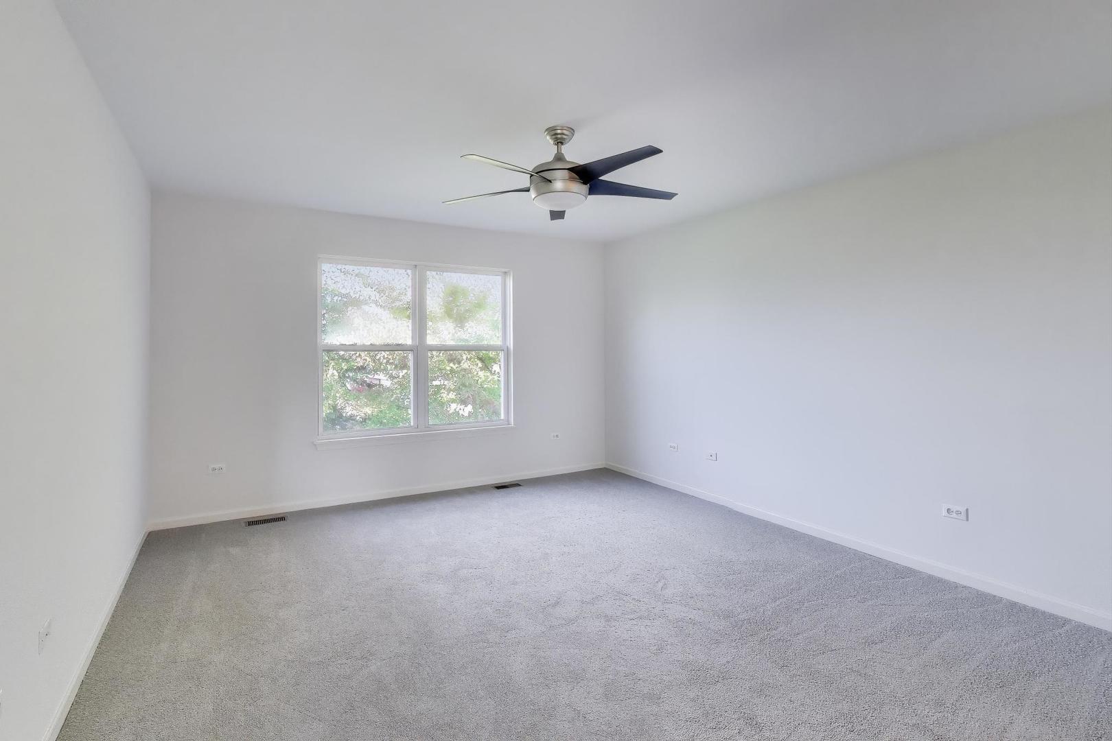 1677 South Candlestick Way Waukegan, IL 60048 - Photo 14 of 30 an empty room with windows and fan