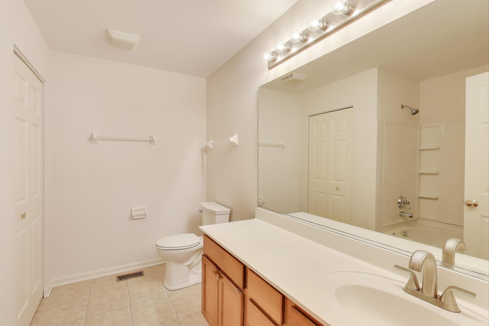 1677 South Candlestick Way Waukegan, IL 60048 - Photo 17 of 30 a bathroom with a sink a toilet and shower