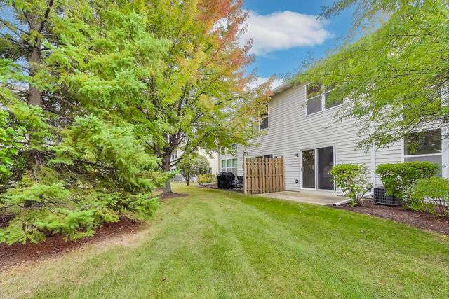 a view of a house with a yard and sitting area