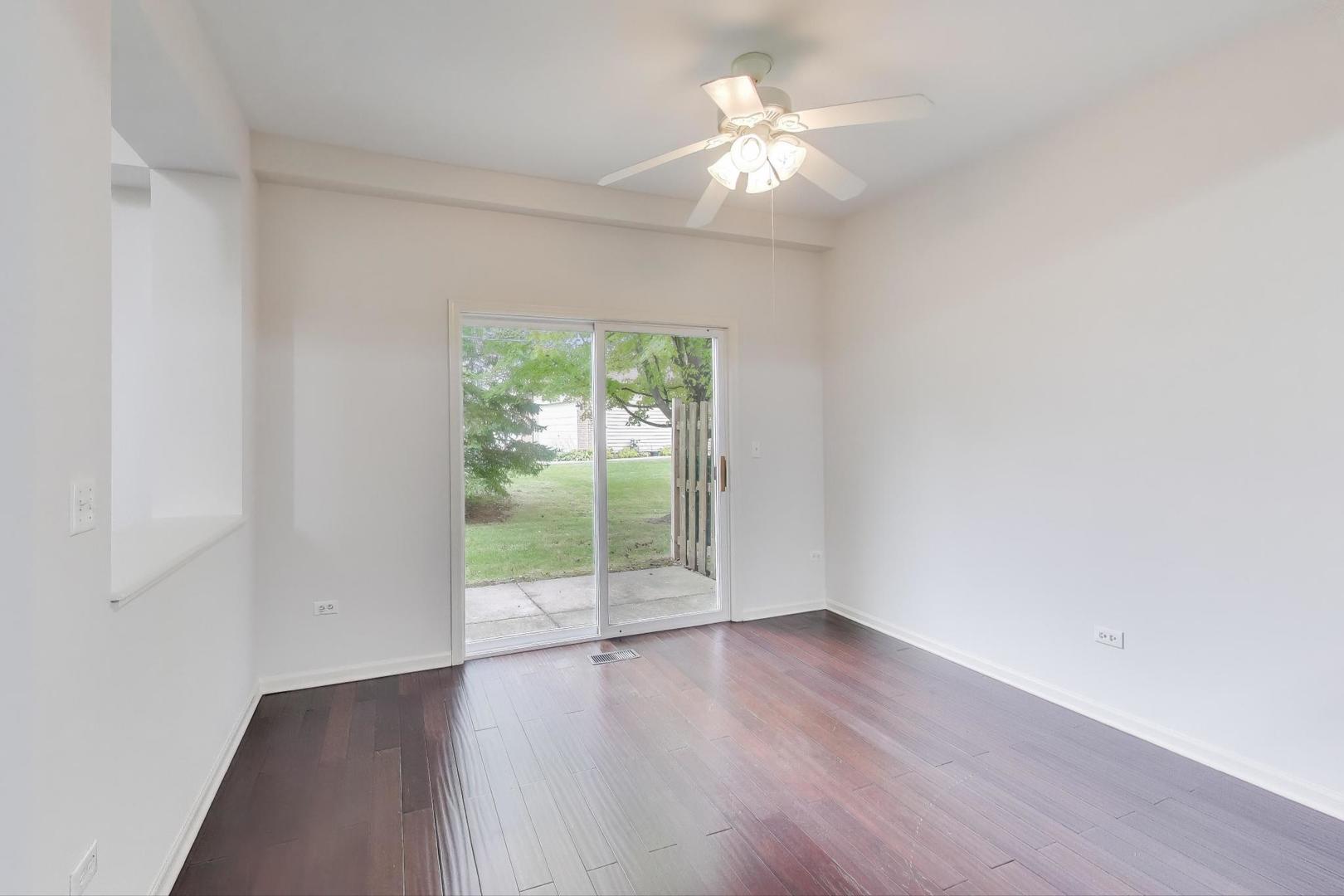 1677 South Candlestick Way Waukegan, IL 60048 - Photo 7 of 30 an empty room with wooden floor and windows