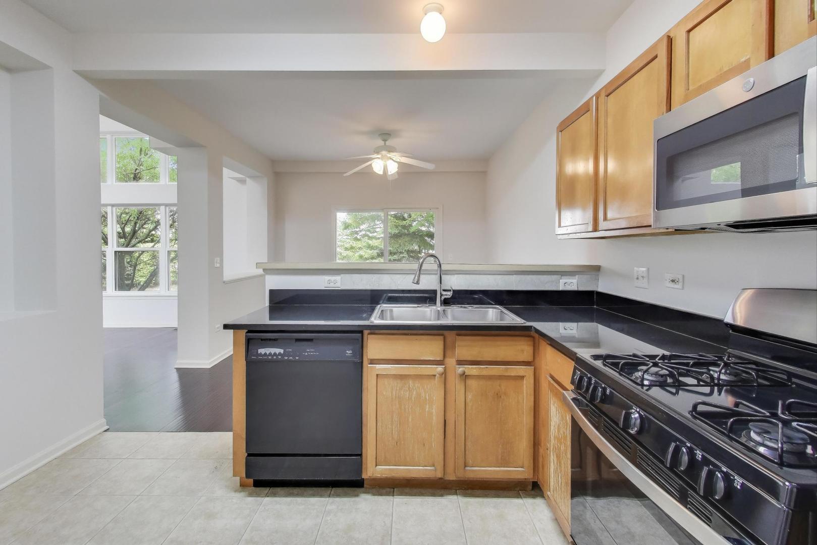 1677 South Candlestick Way Waukegan, IL 60048 - Photo 10 of 30 a kitchen with a stove and a sink