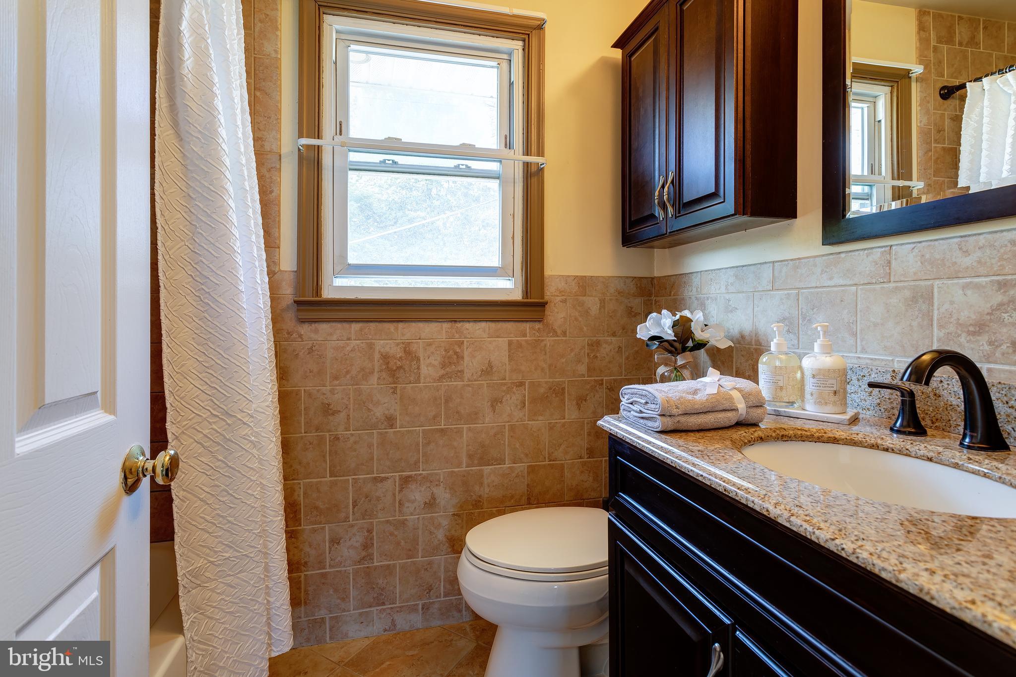 1105 Wynnbrook Road Secane, PA 19018 - Photo 17 of 30 a bathroom with a sink a toilet and a window
