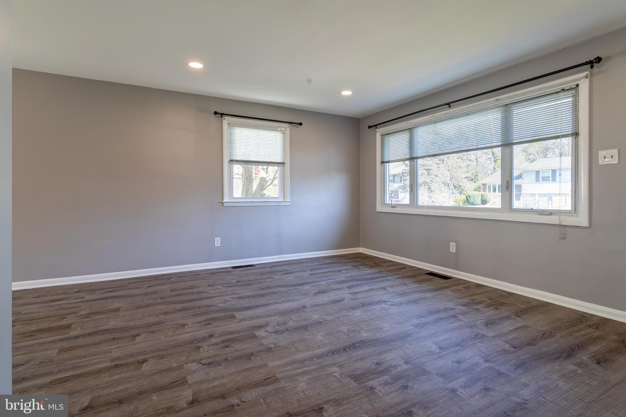 1105 Wynnbrook Road Secane, PA 19018 - Photo 5 of 30 an empty room with wooden floor and windows