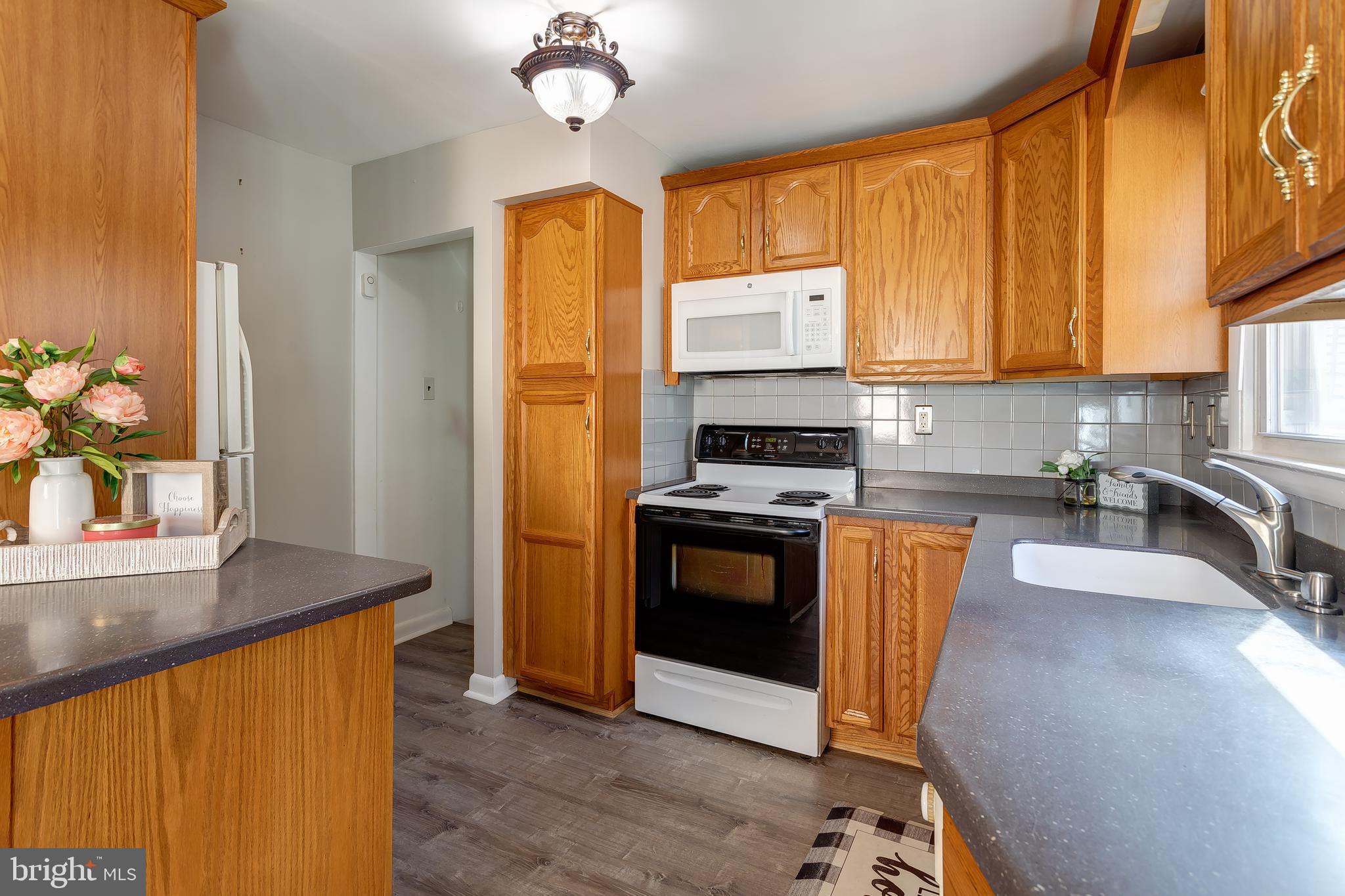 1105 Wynnbrook Road Secane, PA 19018 - Photo 10 of 30 a kitchen with stainless steel appliances granite countertop a stove a sink and a refrigerator