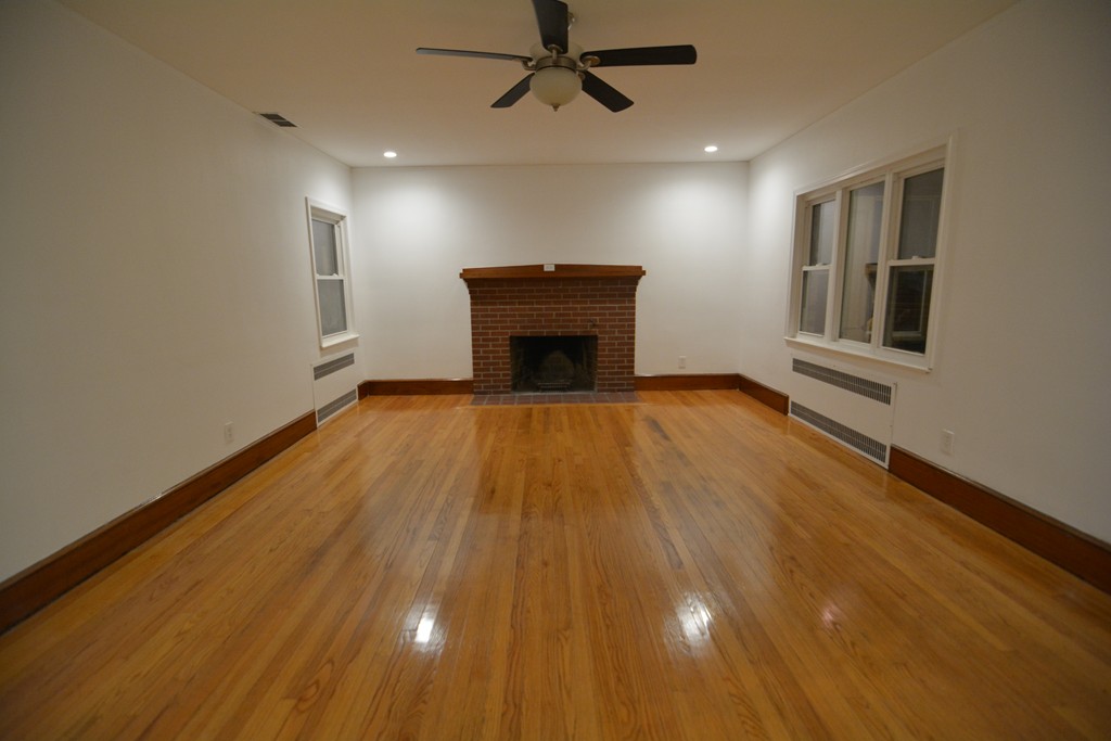 191 Pasco Road Springfield, MA 01151 - Photo 2 of 20 a view of a livingroom with a fireplace and wooden floor