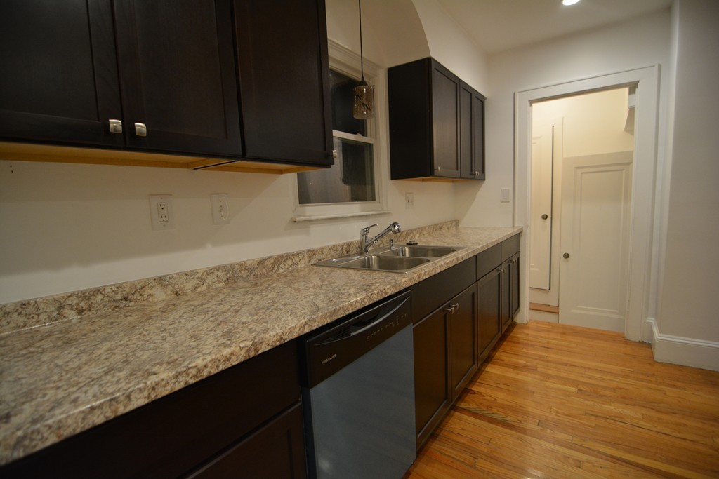 191 Pasco Road Springfield, MA 01151 - Photo 6 of 20 a kitchen with granite countertop sink cabinets and stainless steel appliances