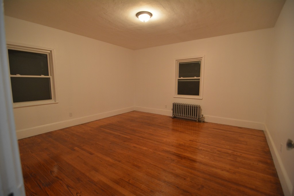 191 Pasco Road Springfield, MA 01151 - Photo 8 of 20 an empty room with wooden floor and windows