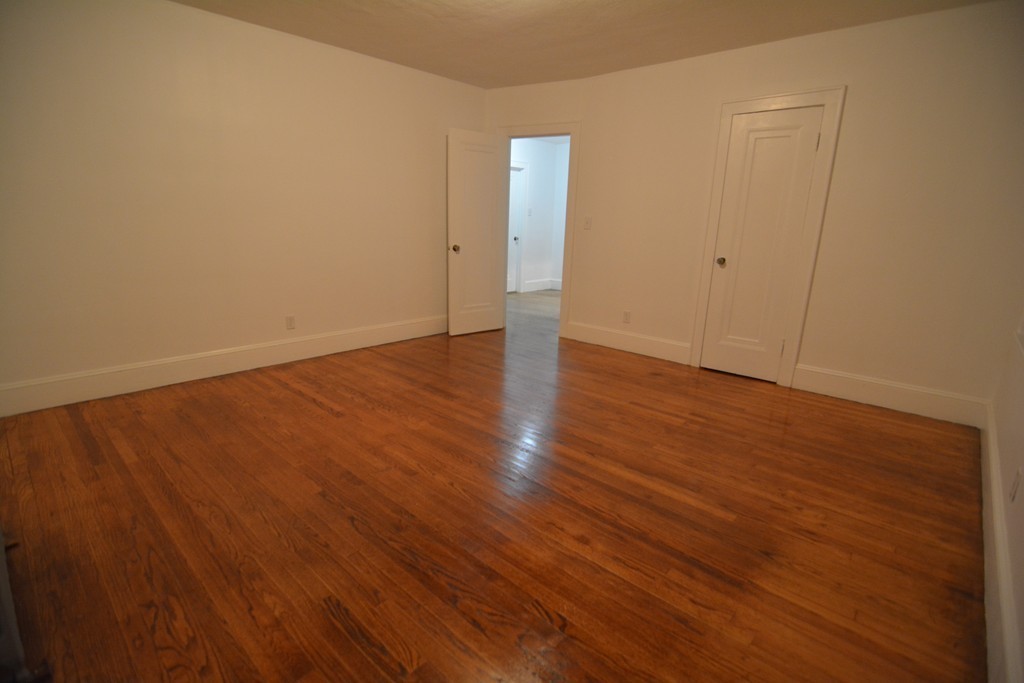 191 Pasco Road Springfield, MA 01151 - Photo 9 of 20 a view of an empty room with wooden floor and a window