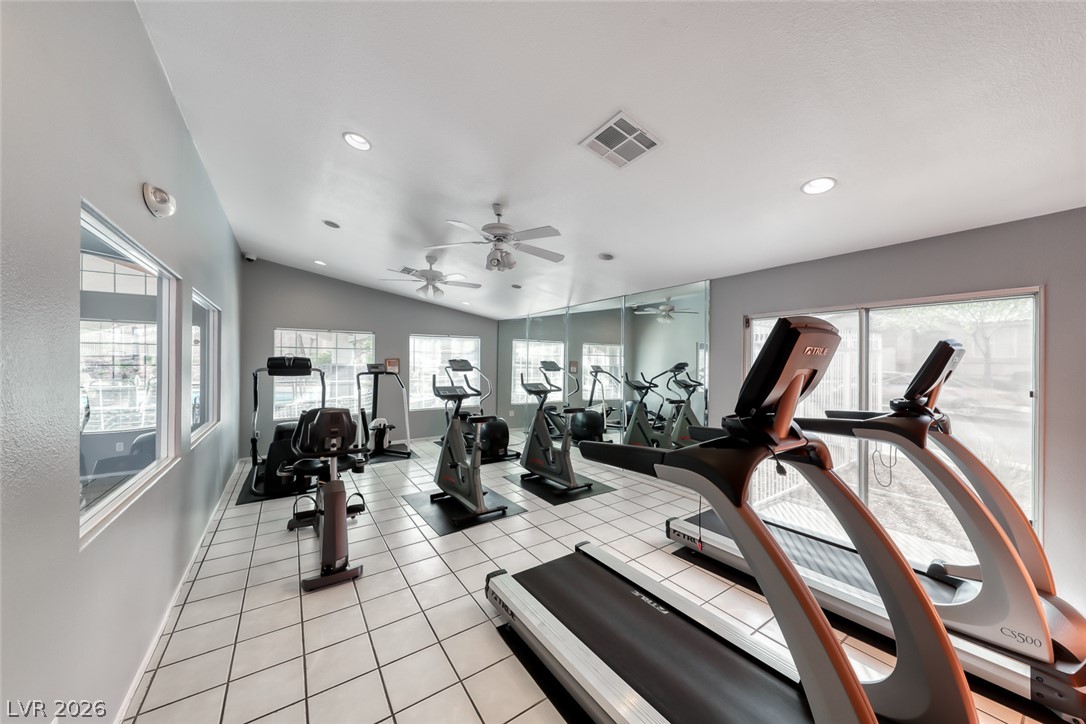 205 Genesee Point Street Henderson, NV 89074 - Photo 27 of 30 Tiled flooring and mirrored walls define this well-lit fitness space featuring multiple large windows.