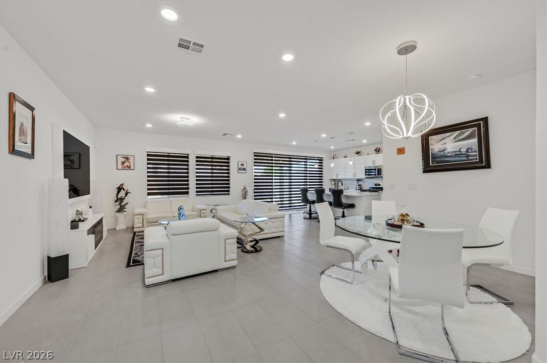 2933 Little Current Road North Las Vegas, NV 89086 - Photo 35 of 35 An open floorplan seamlessly connects the well-lit living area and dining space.