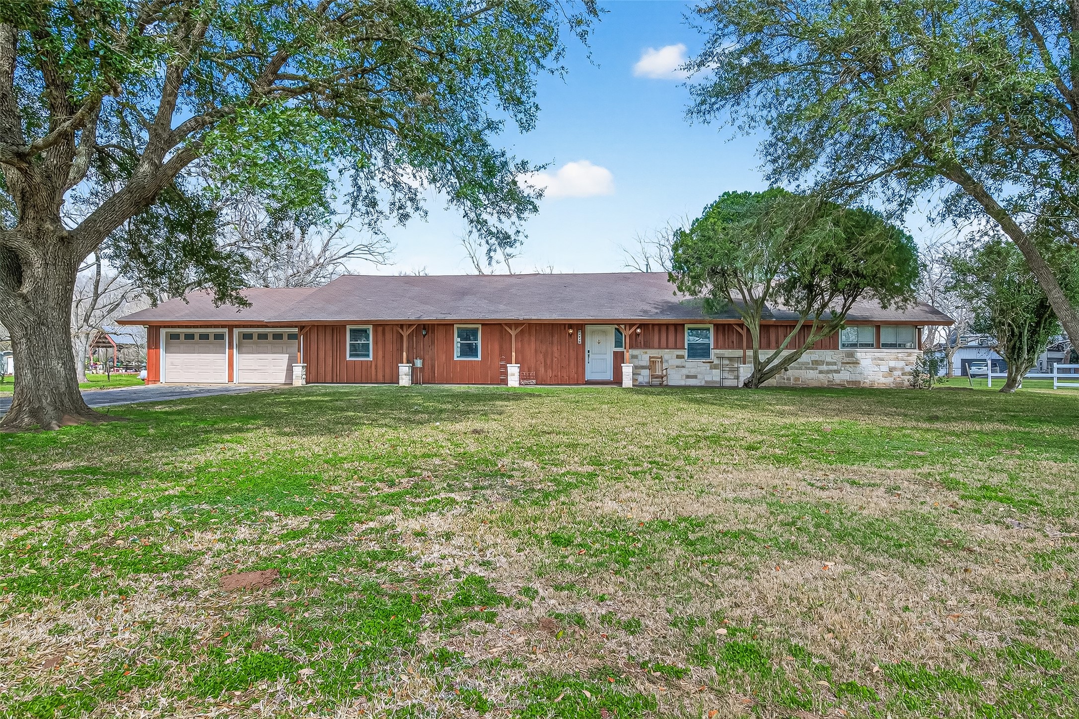 403 Wrangler Road Simonton, TX 77485 - Photo 1 of 33 a front view of a house with a garden