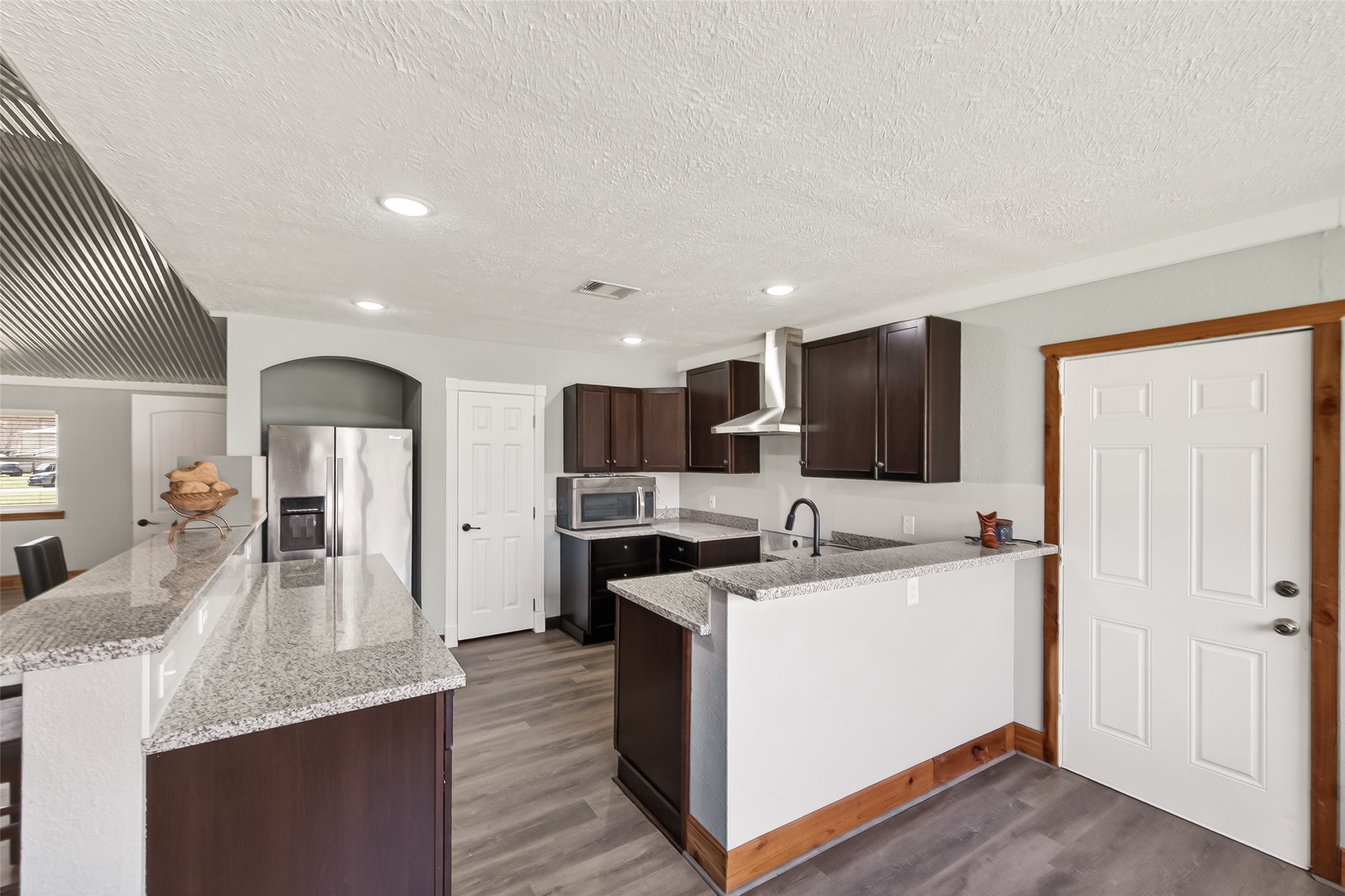403 Wrangler Road Simonton, TX 77485 - Photo 11 of 33 a kitchen with stainless steel appliances kitchen island sink refrigerator and cabinets