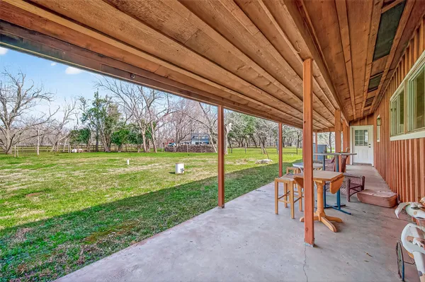 a view of a house with backyard porch and sitting area