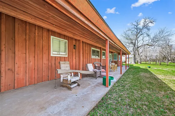 a backyard of a house with outdoor seating