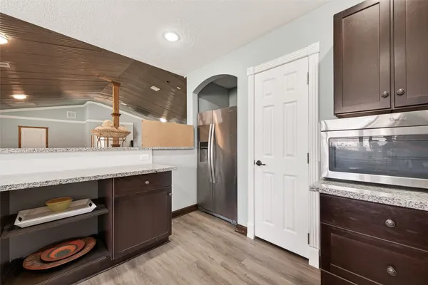 a kitchen with stainless steel appliances granite countertop a refrigerator and a stove