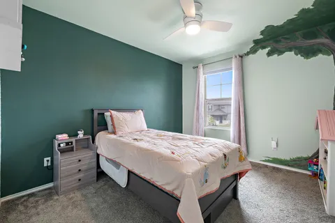 a bedroom with a bed and a chandelier