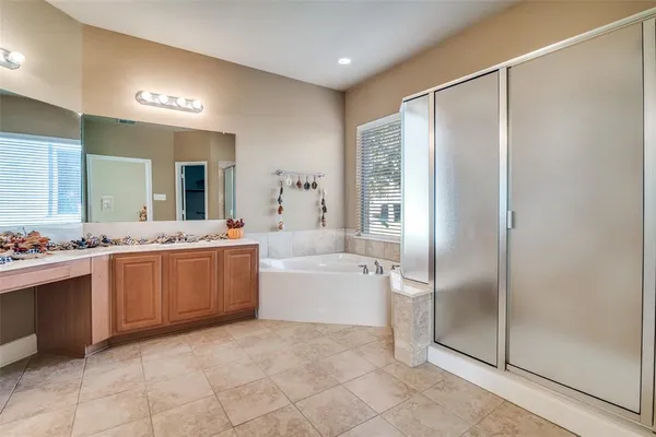 a large bathroom with a glass door shower a sink and a mirror