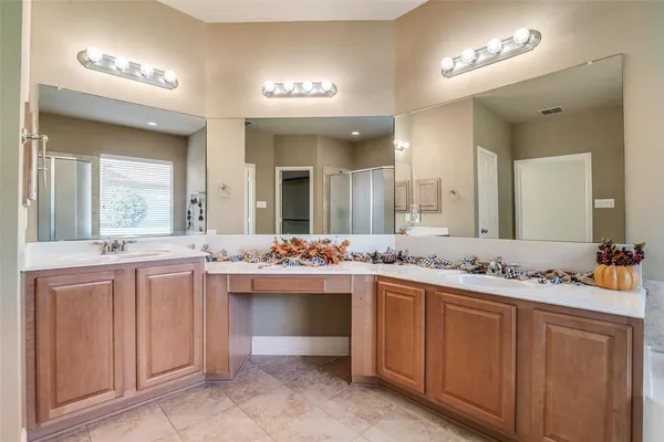 a bathroom with a sink vanity and mirror