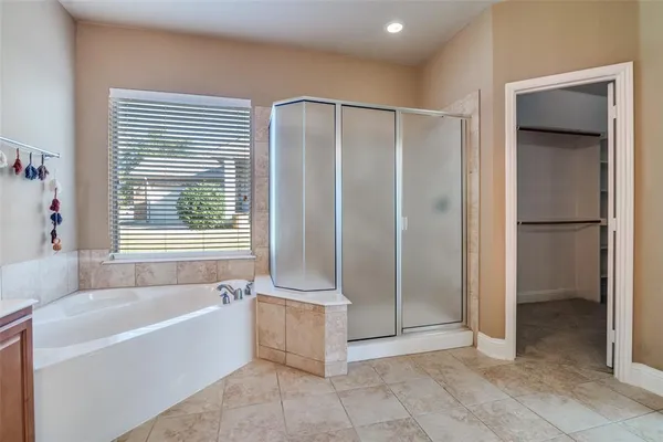 a bathroom with a bathtub and a shower