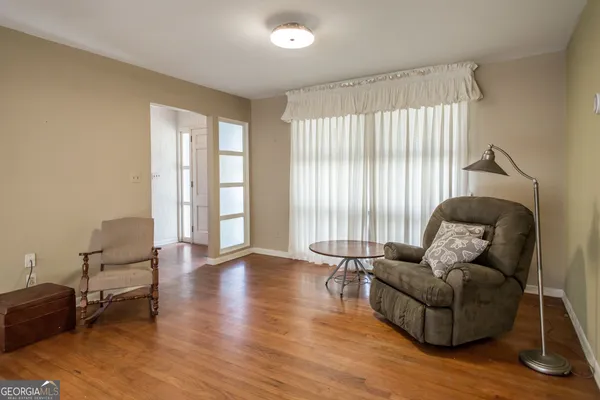 a living room with furniture and a wooden floor