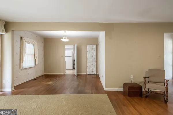a view of an empty room with wooden floor