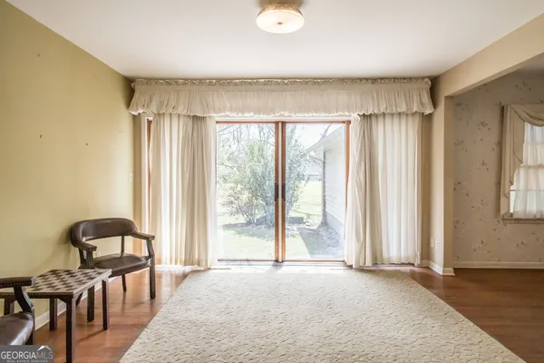 a view of a livingroom with furniture and a book shelf