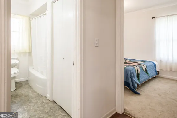 a bed sitting in a bedroom next to a window