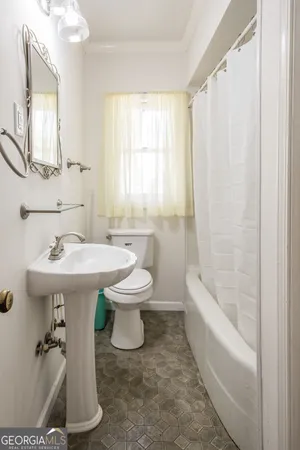a bathroom with a sink a toilet and tub