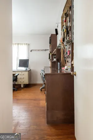 a spacious bedroom with a bed and wooden floor