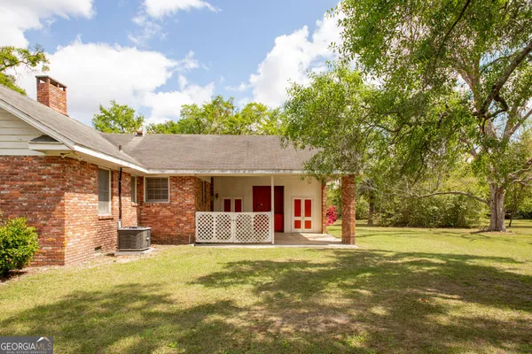 a front view of house with yard and trees