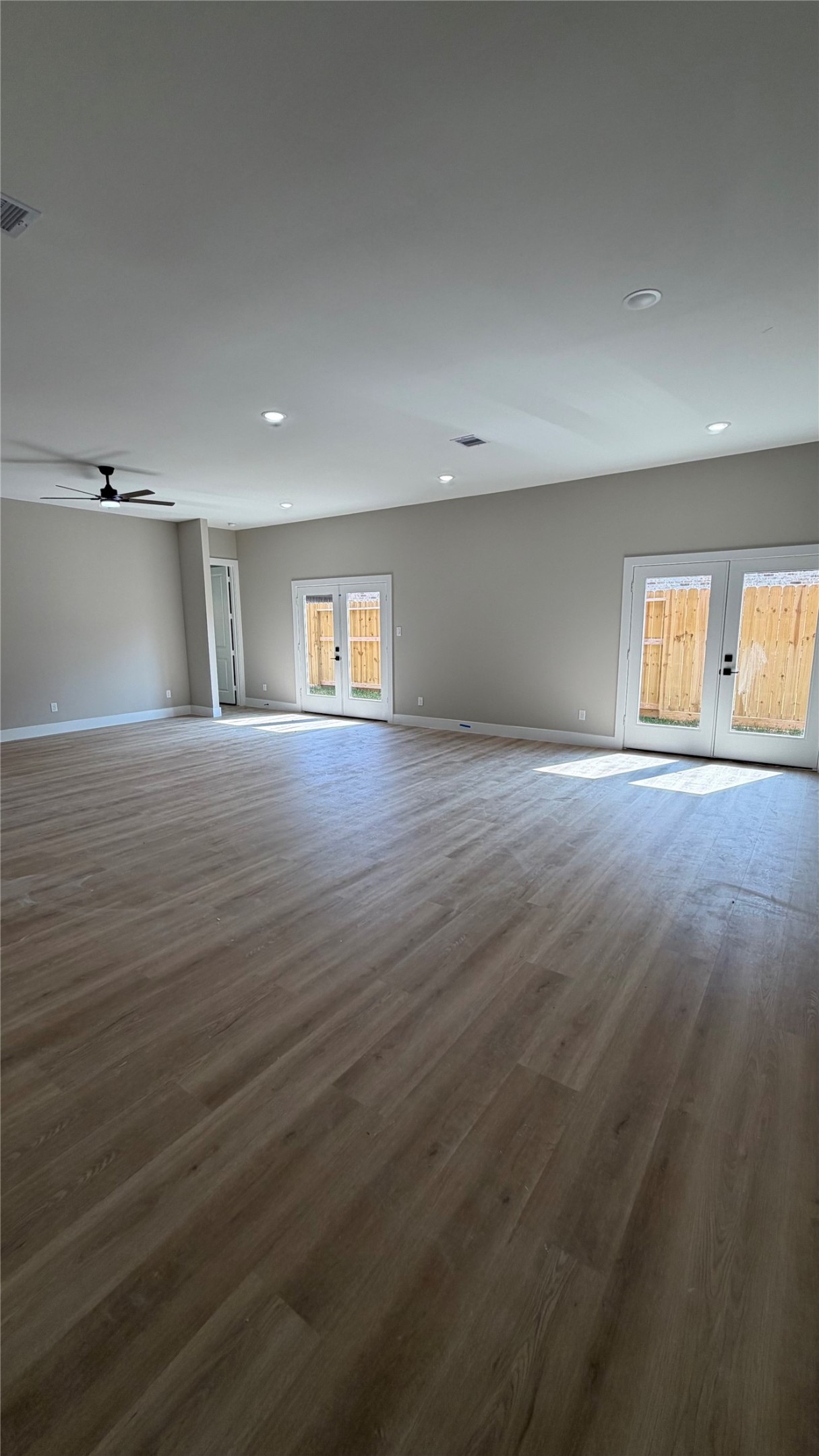 2607 Piemonte Avenue Cir Spring Spring, TX 77388 - Photo 11 of 38 an empty room with wooden floor and windows